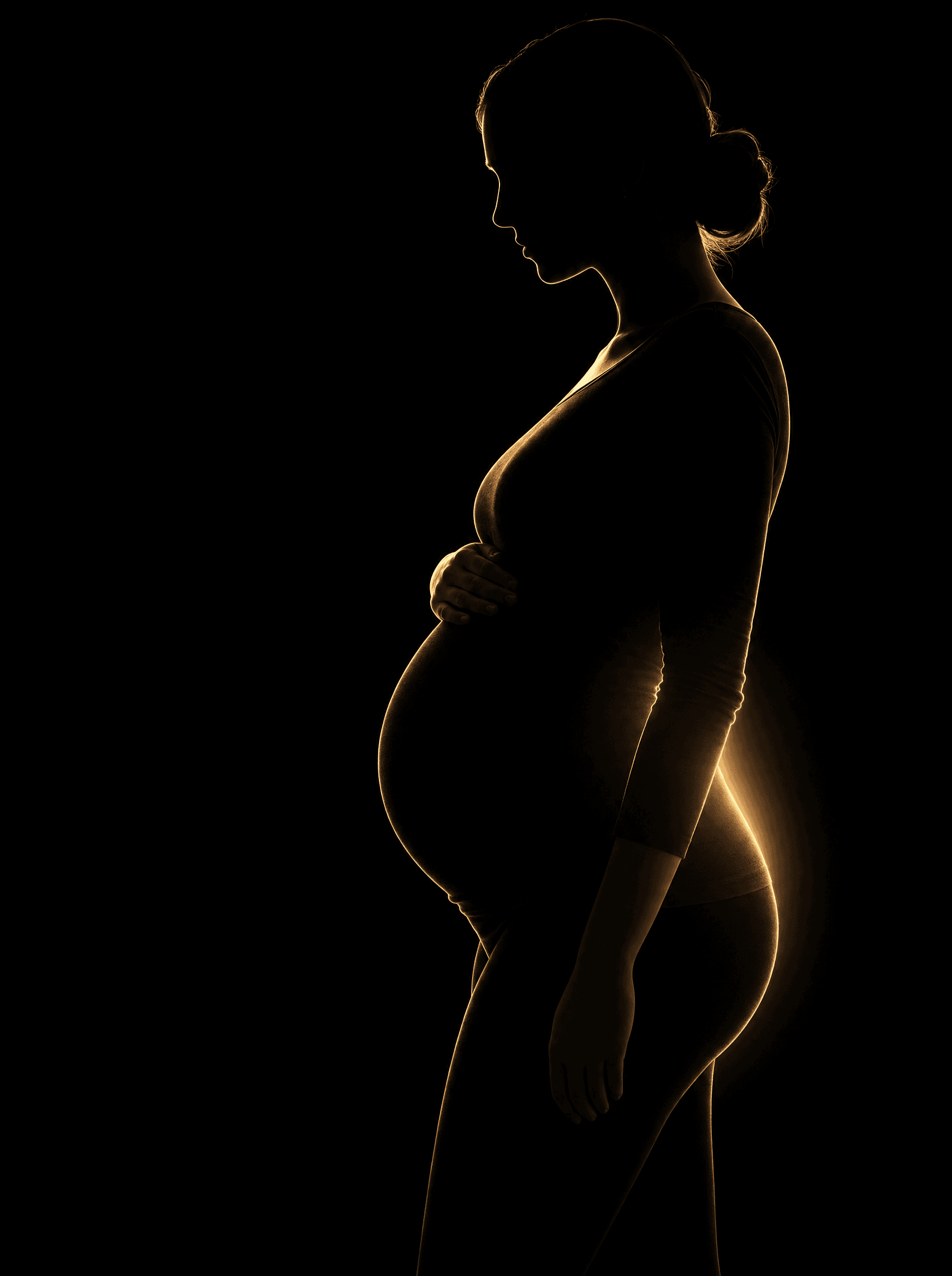 Golden rim-light silhouette illustration of a pregnant woman, representing Prenatal Chiropractic at Infinite Health Group