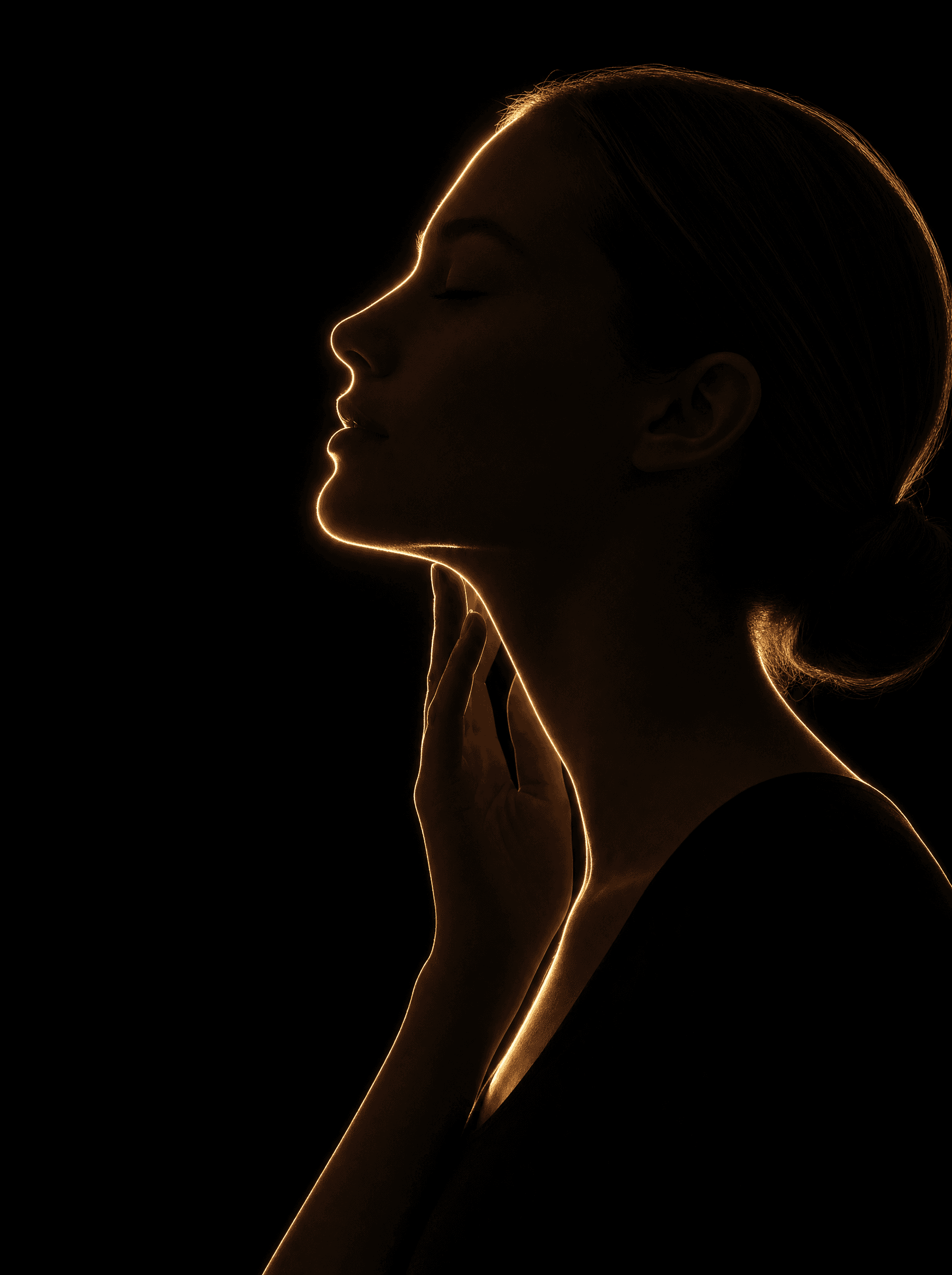 Golden rim-light silhouette illustration highlighting the face and neck, representing Regenerative & Aesthetics at Infinite Health Group